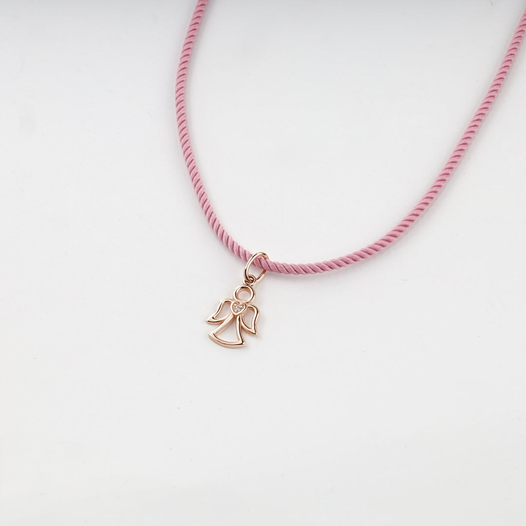 Rose gold guardian angel pendant with a heart, studio view