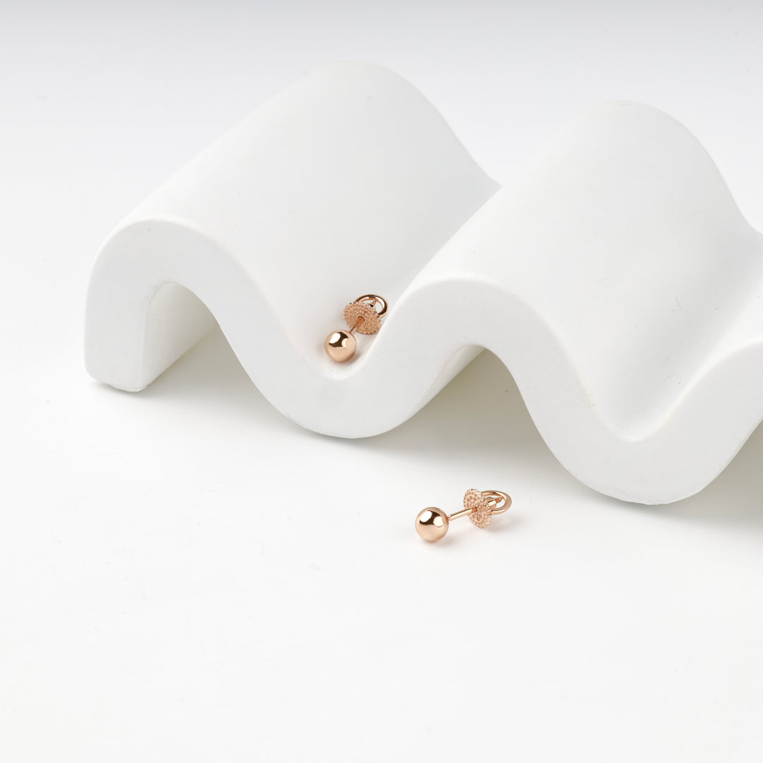 Rose gold 585 ball stud earrings worn without the pearl drops