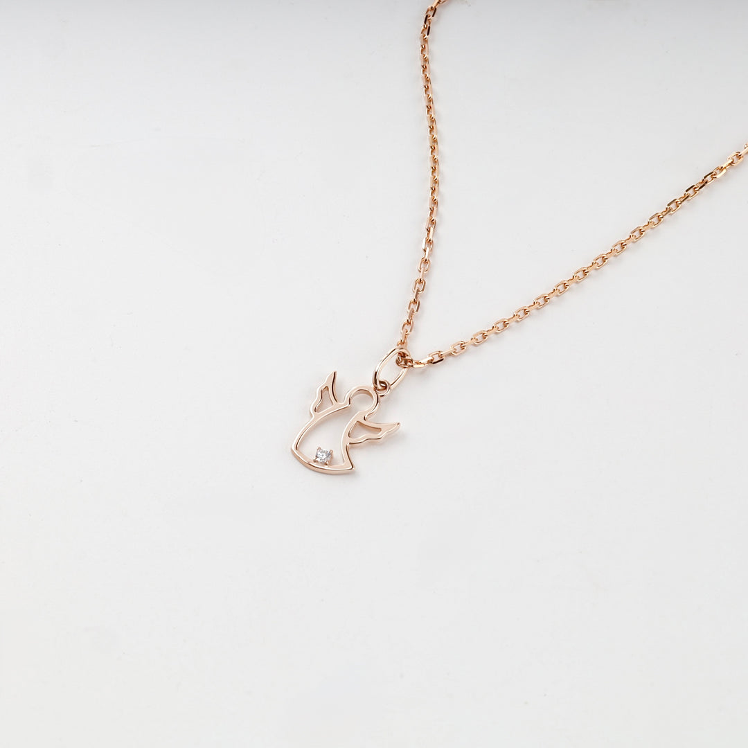 Rose gold guardian angel pendant with raised wings, studio view