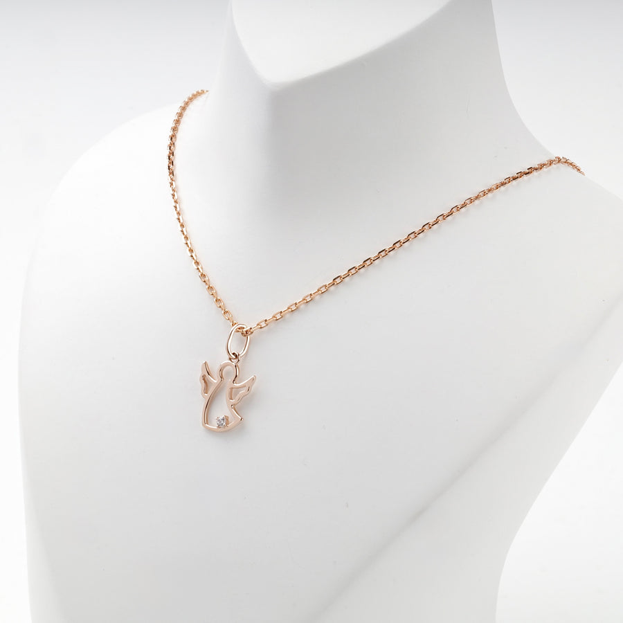 Rose gold angel pendant worn on a rose gold chain