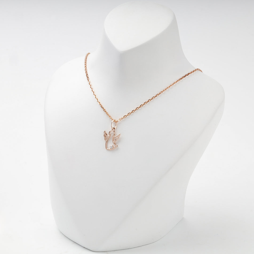 Rose gold openwork angel pendant with raised wings and cubic zirconia, overhead view