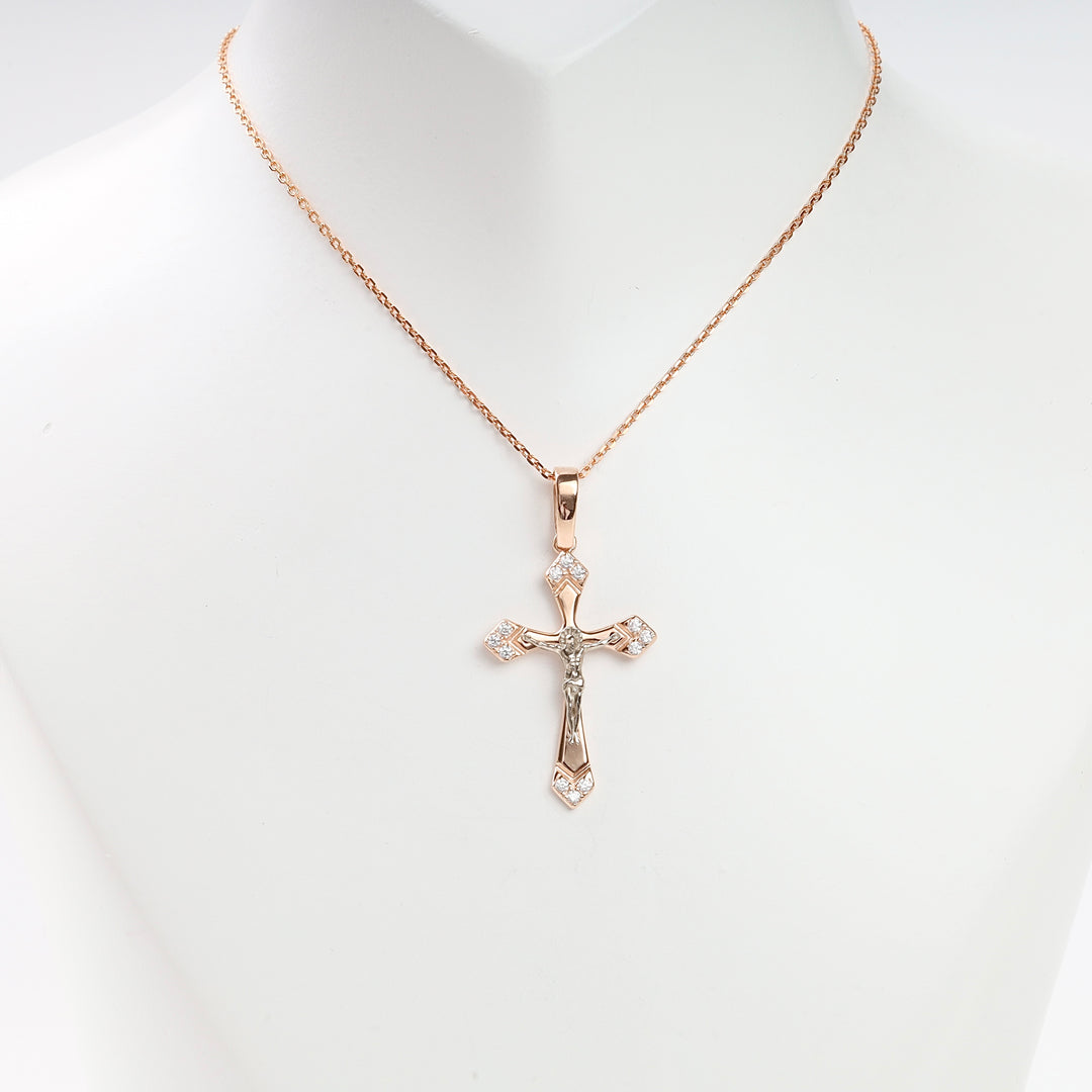 Rose gold cross pendant necklace with cubic zirconia accents and Jesus motif displayed on a white jewelry bust.