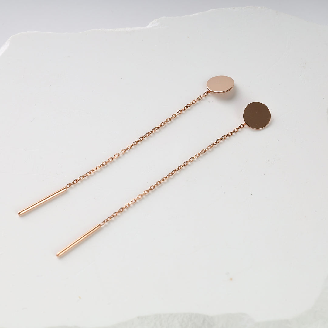 Rose gold threader earrings with round disc studs and delicate chain, shown on a white background.