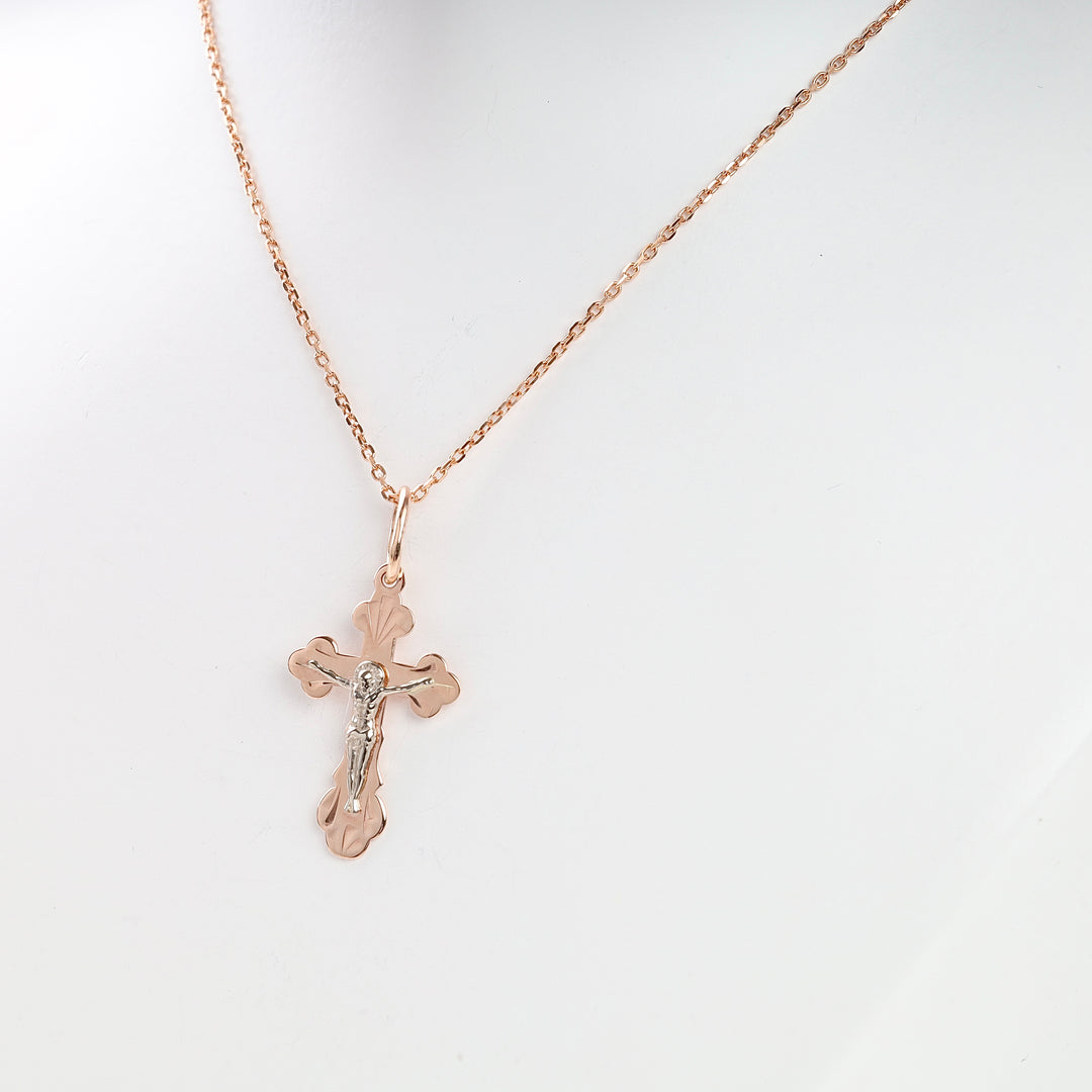 Rose gold cross necklace with a silver Jesus figure pendant displayed on a white bust. Christian jewelry, crucifix, gift.