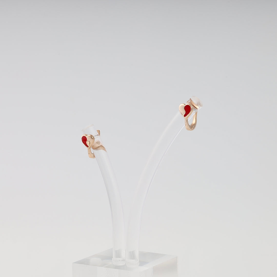 14k gold earrings with small red enamel heart studs on clear display, romantic Ukrainian Jewelry, dainty gold heart earrings.