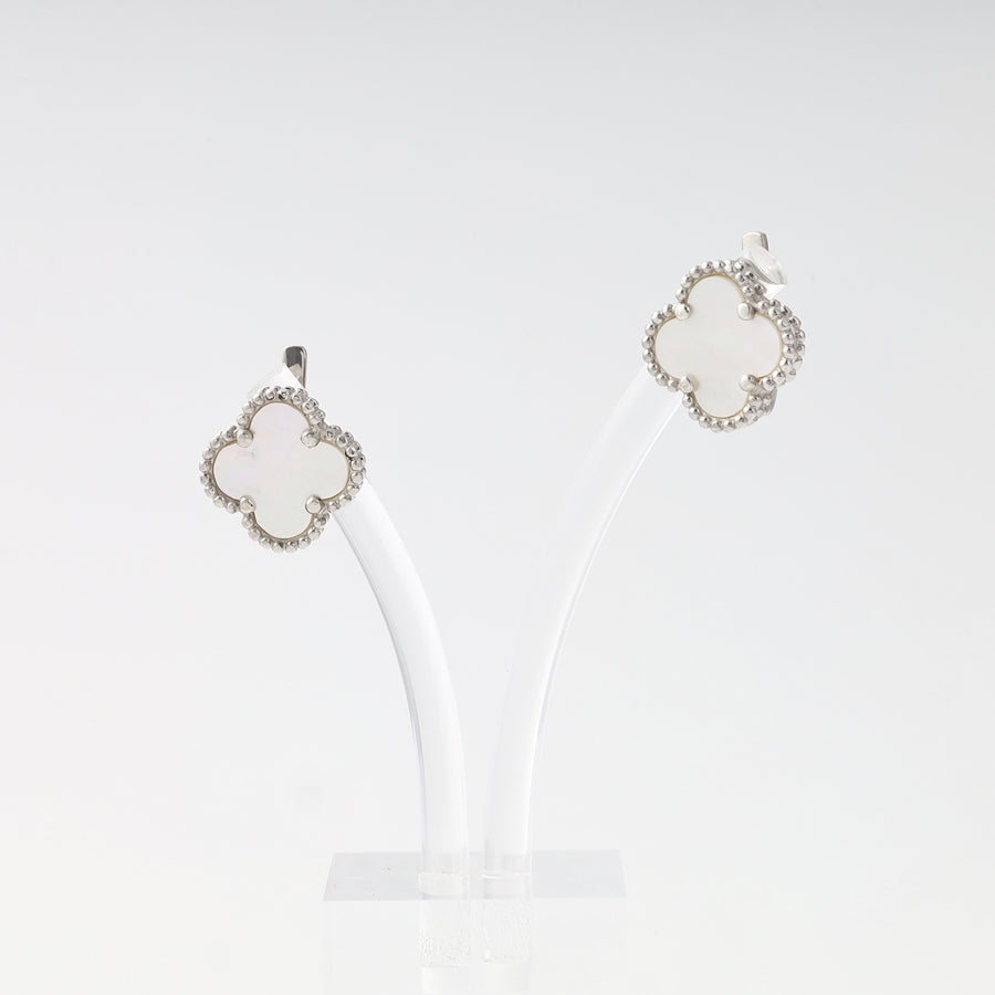 Sterling silver clover stud earrings with white enamel on display, Ukrainian Jewelry, elegant silver earrings for women.