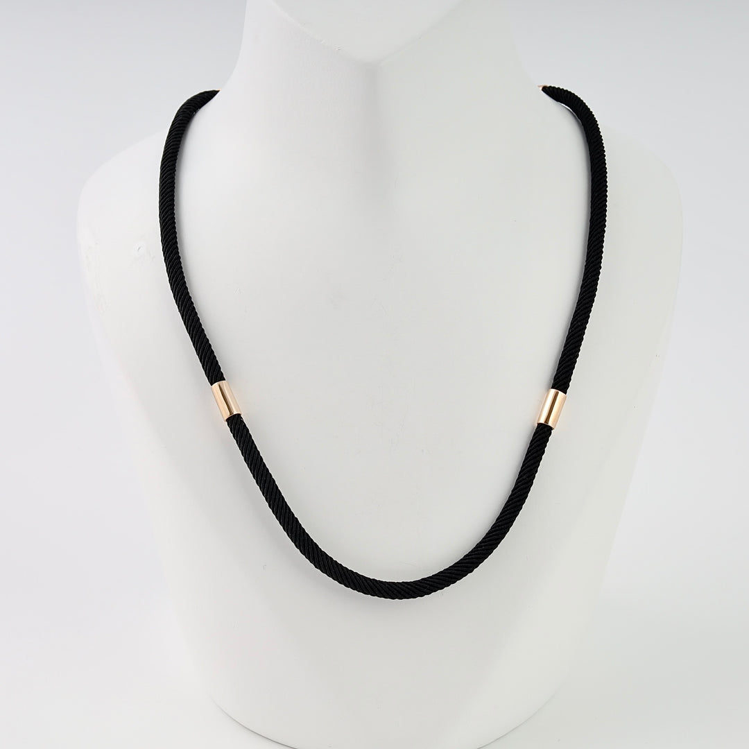 Black cord necklace with two small gold tube accents on bust display, minimalist Ukrainian Jewelry, black necklace, gold choker.