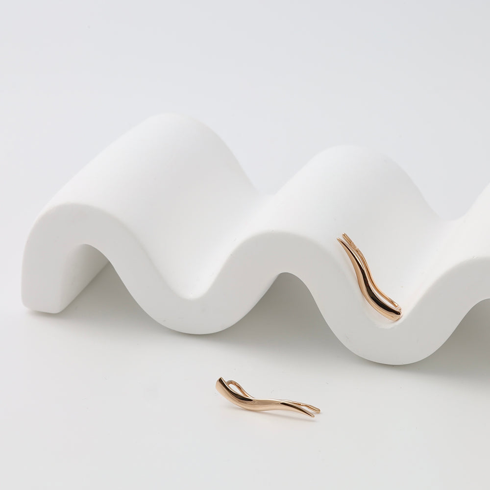 Rose gold earrings with twisted bar design on white display, minimalist 14k gold jewelry, Ukrainian Jewelry, modern gold drop earrings.