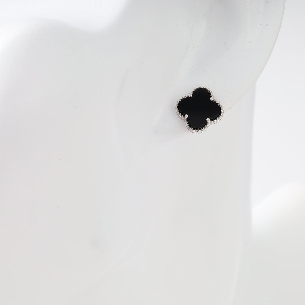 Sterling silver black clover stud earring on ear, minimalist Ukrainian Jewelry, small silver stud earrings.