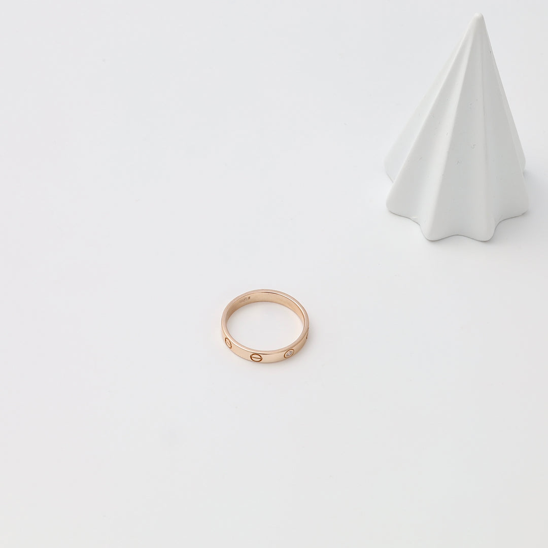 Rose 14k gold band ring with engraved circle motif on white display surface, minimalist Ukrainian Jewelry wedding ring.