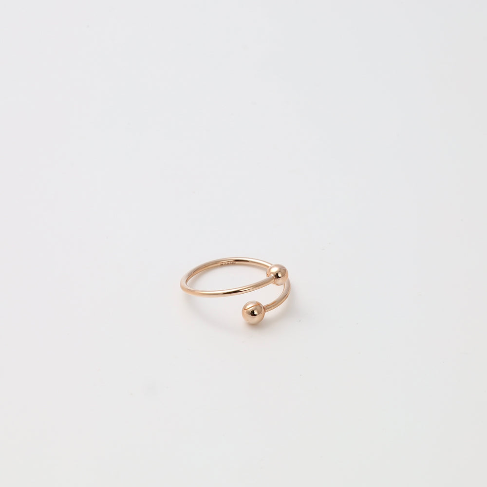 Minimalist 14k gold open ring with two ball ends on white background, modern stacking ring Ukrainian Jewelry gift.