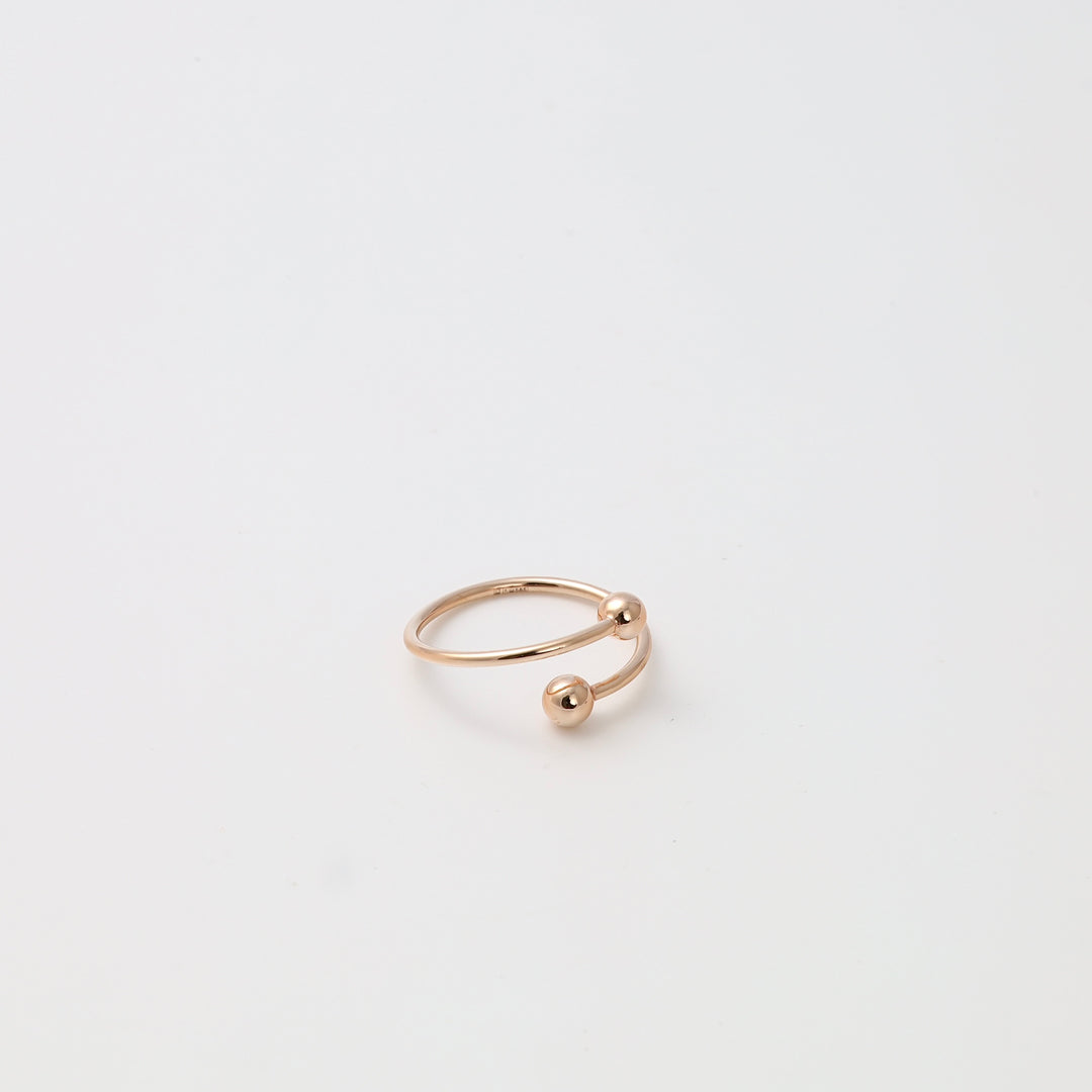 Minimalist 14k gold open ring with two ball ends on white background, modern stacking ring Ukrainian Jewelry gift.