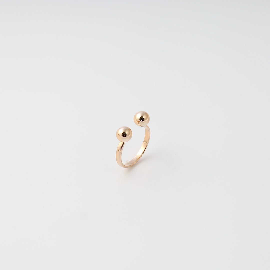 Minimalist 14k gold open ring with two spheres displayed on white background, Ukrainian Jewelry, modern gold stacking ring.