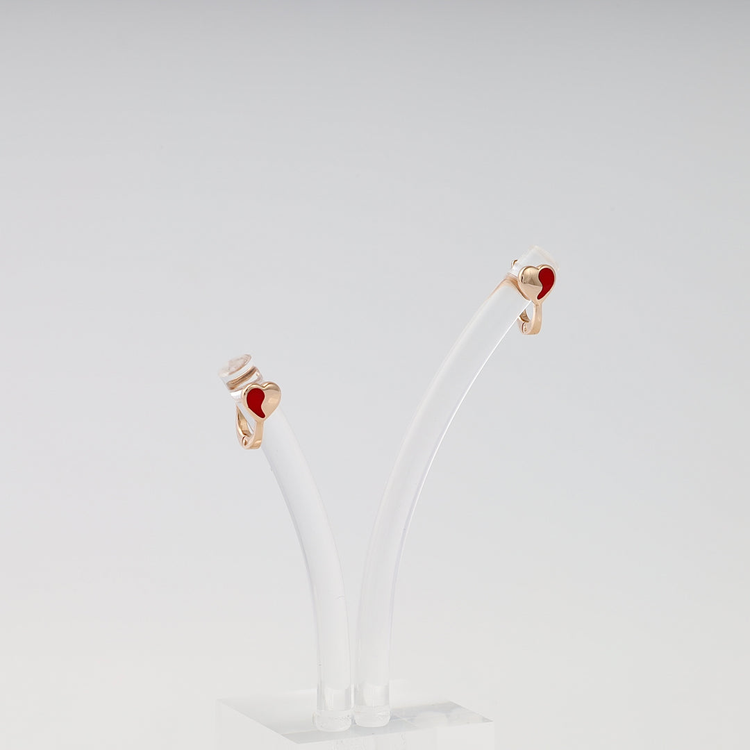 14k gold hoop earrings with red heart charm, displayed on clear stand, romantic Ukrainian Jewelry gift, minimalist gold earrings.