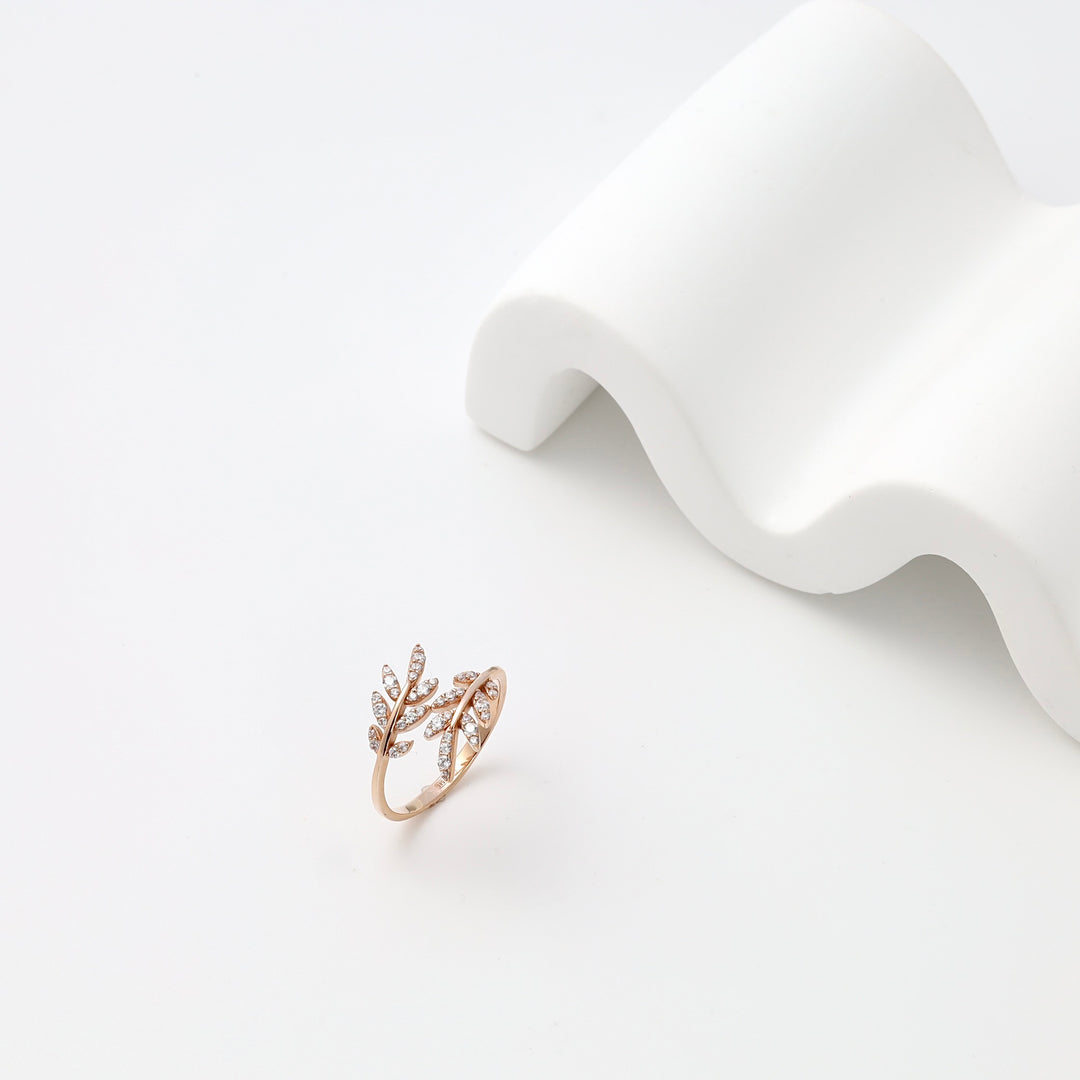 14k gold leaf ring with crystal accents on white display, delicate branch design Ukrainian Jewelry for women, gold statement ring.