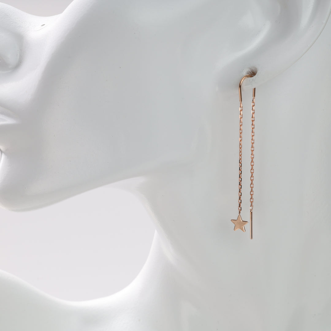 Rose gold chain threader earrings with star charm displayed on a white mannequin.