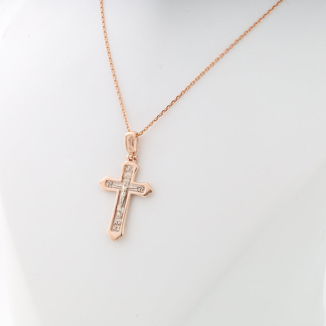 Rose gold cross necklace with silver crucifix detail on a fine chain, displayed on a white bust. Cross pendant, religious jewelry.