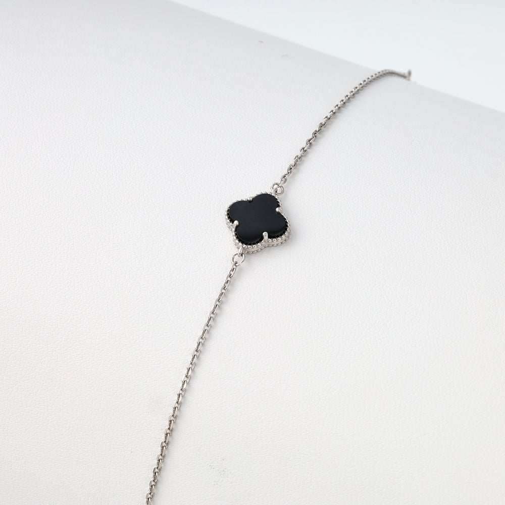 Sterling silver bracelet with black clover charm on display, minimalist Ukrainian Jewelry, dainty silver chain bracelet.