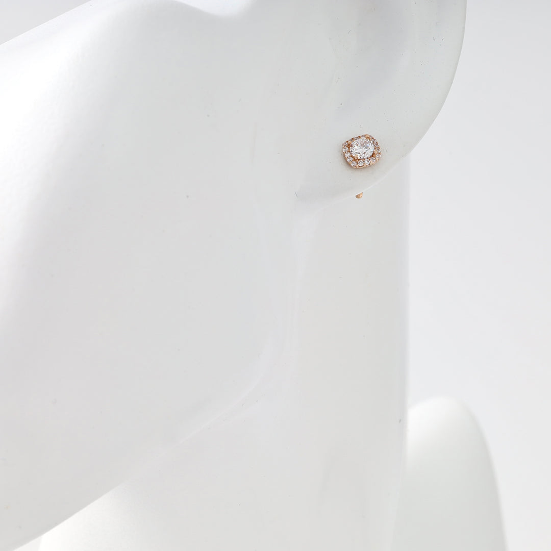 Single 14k gold cushion-cut stud earring with clear stone on ear display, Ukrainian Jewelry, minimalist gold stud earrings.