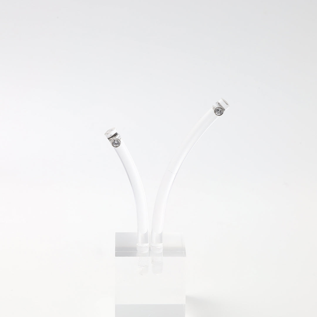 Sterling silver stud earrings with clear gemstones on white curved display, minimalist Ukrainian Jewelry, simple silver earrings.