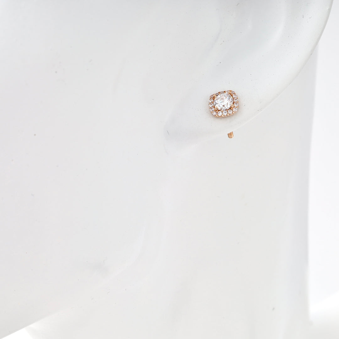 Single 14k gold stud earring with cushion halo and clear stones shown on ear, Ukrainian Jewelry, diamond stud earring gift.