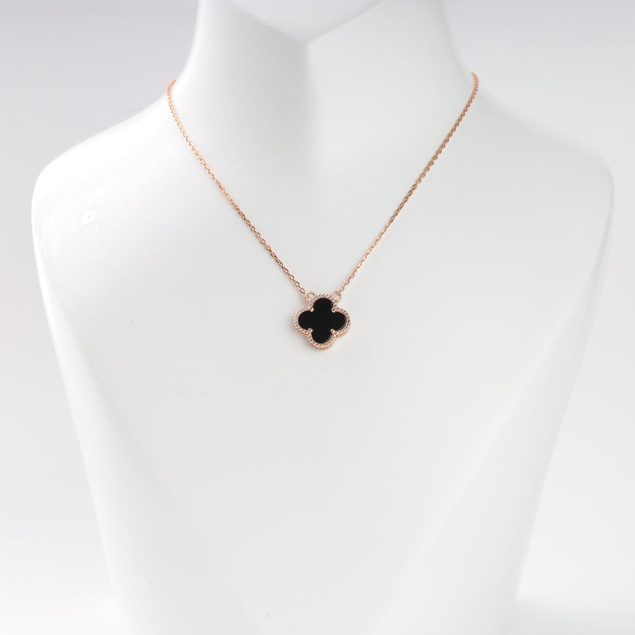 Gold chain necklace with a black clover pendant displayed on a white bust, suitable for jewelry, clover necklace, gold pendant.