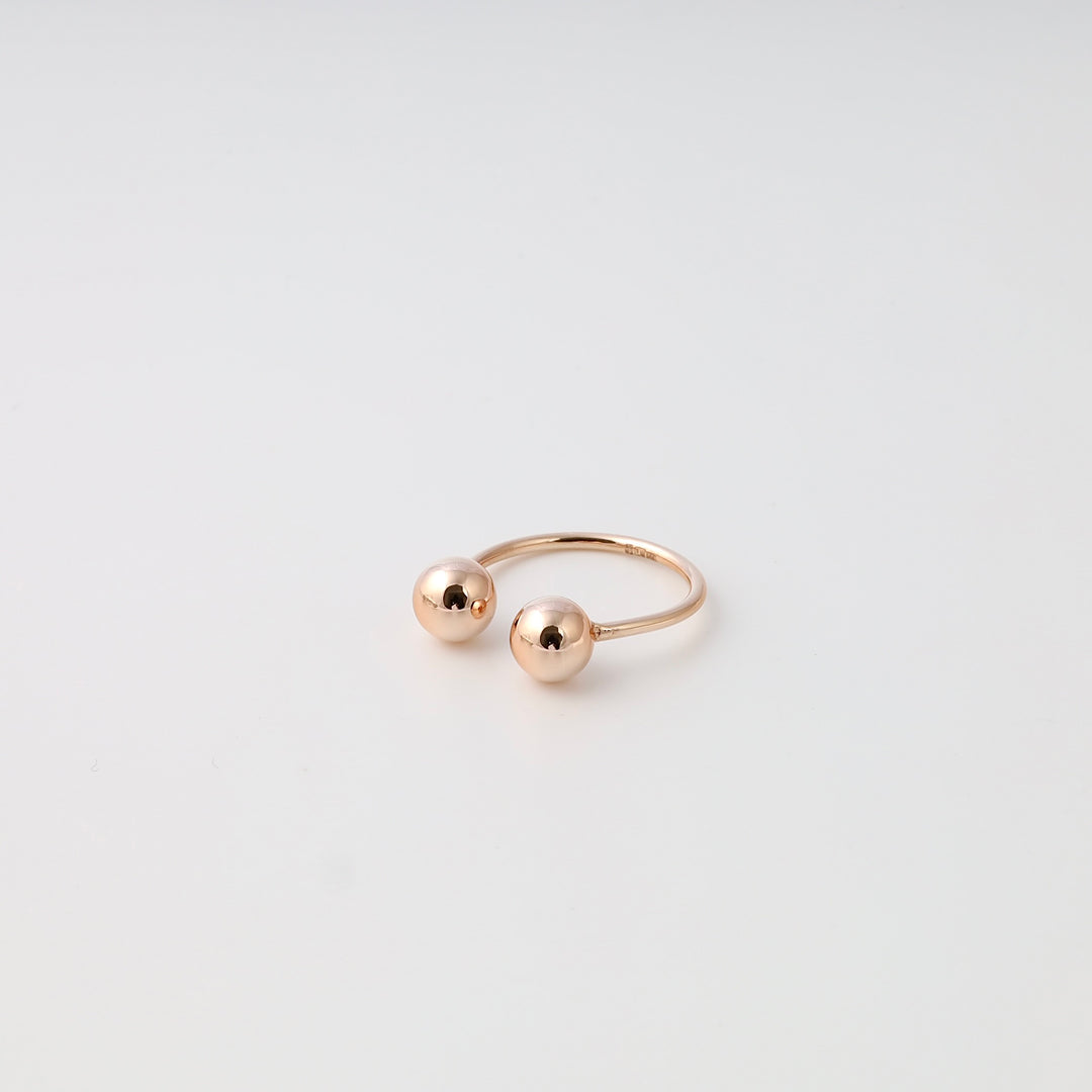 Minimalist 14k gold open ring with two round ball ends on white background, modern stackable Ukrainian Jewelry, dainty gold ring.
