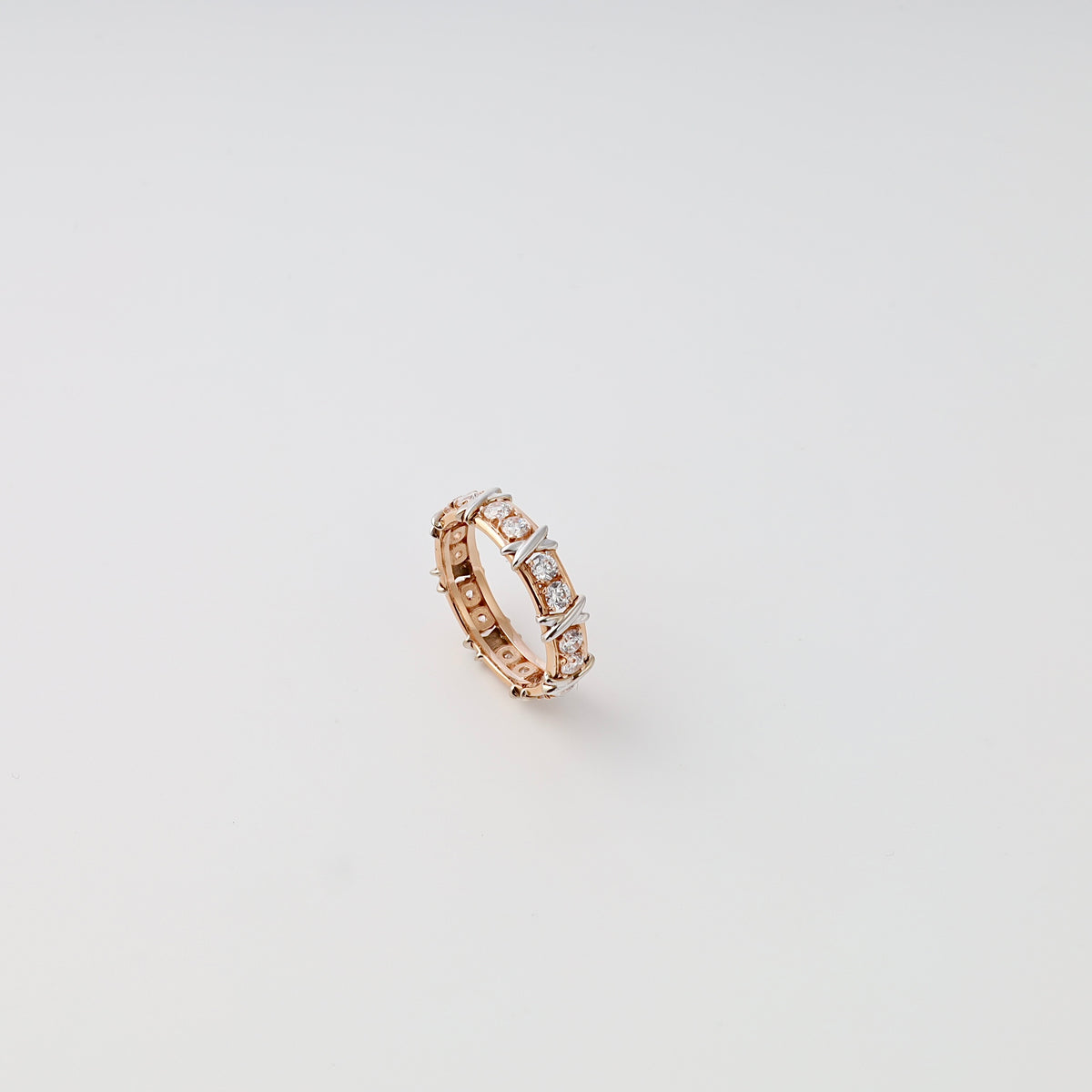 14k gold eternity ring with round cubic zirconia stones in prong setting on white background, Ukrainian Jewelry, bridal wedding band.