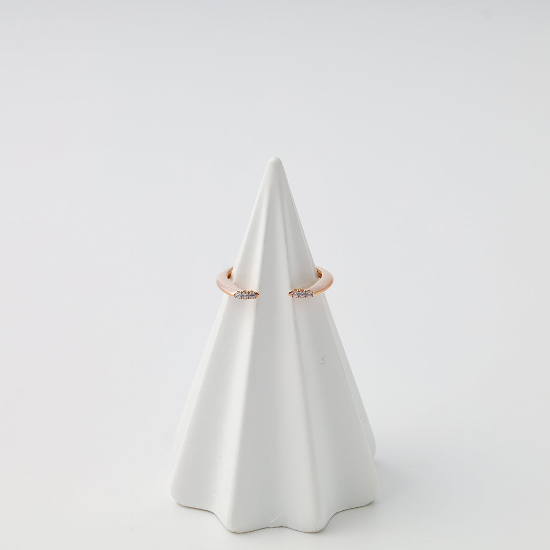 Rose gold ring with small crystal accents displayed on white cone, 14k gold minimalist band, Ukrainian Jewelry, delicate stacking ring.