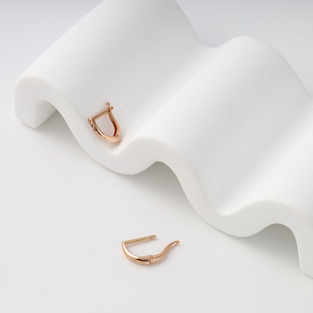Pair of small rose gold hoop earring findings on white display, 14k gold ear wire hooks, minimalist Ukrainian Jewelry for DIY earrings.