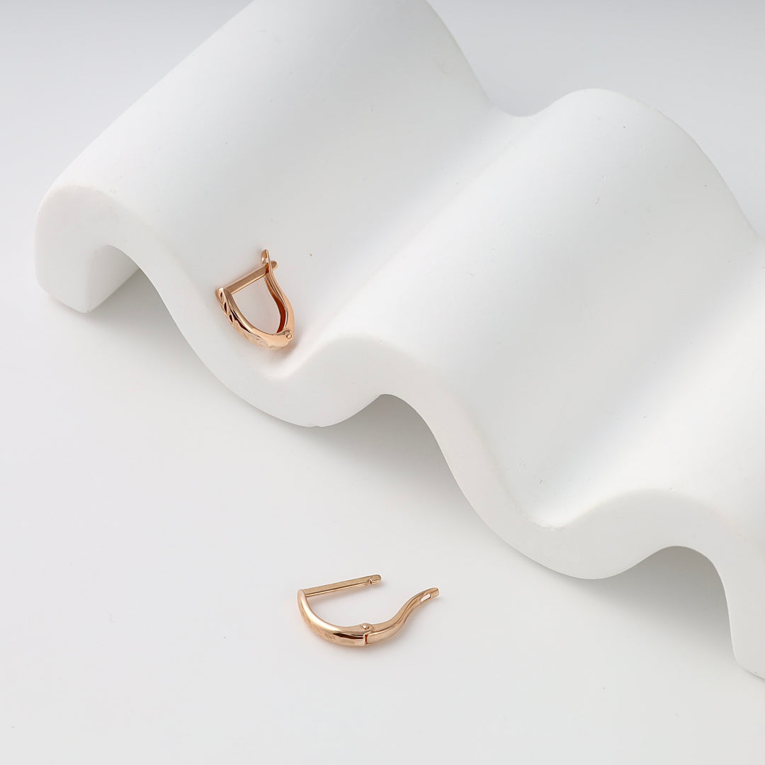 Pair of small rose gold hoop earring findings on white display, 14k gold ear wire hooks, minimalist Ukrainian Jewelry for DIY earrings.