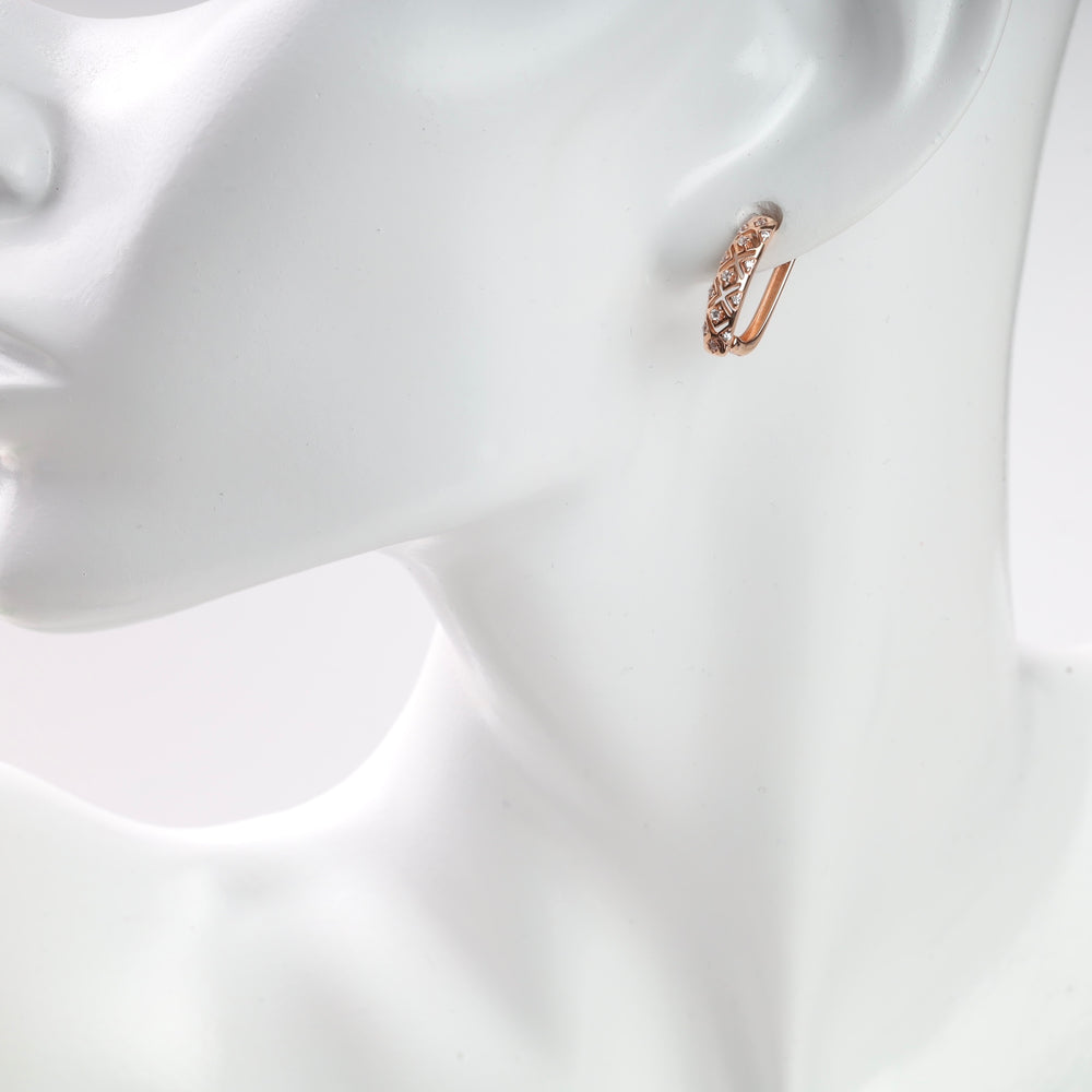 Rose gold diamond-patterned hoop earring on a white mannequin.