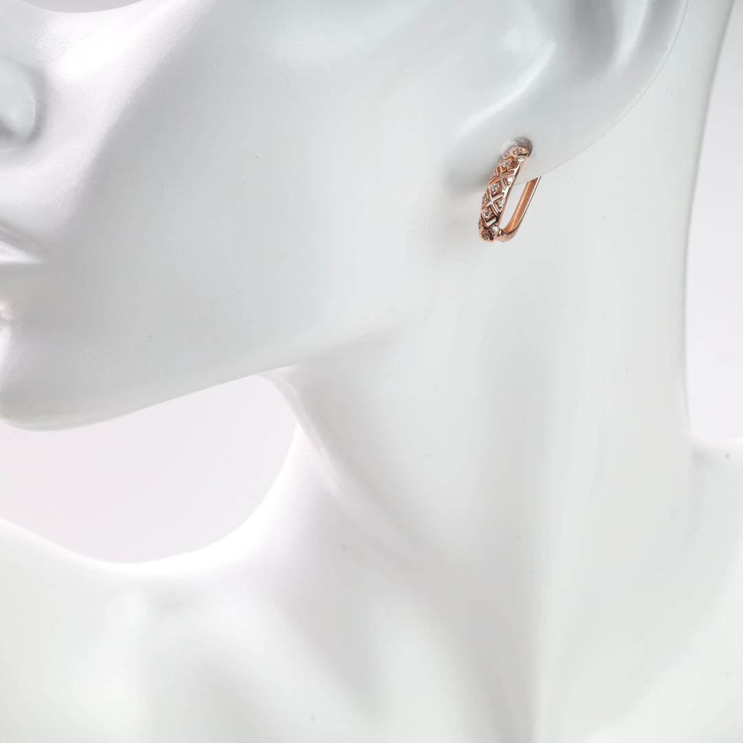 Rose gold diamond-patterned hoop earring on a white mannequin.