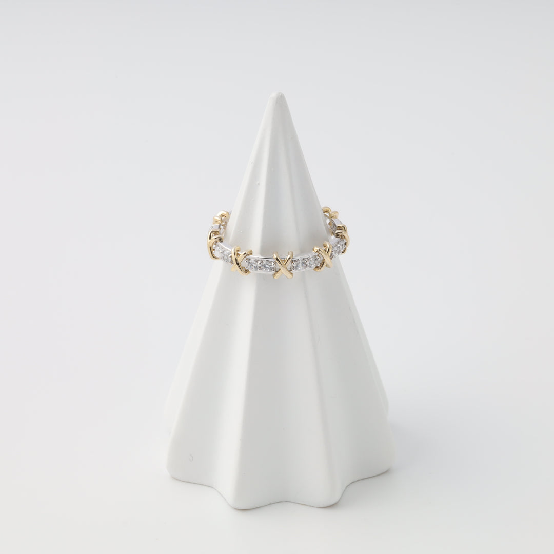 Gold ring with crystal stones in X motif on white cone display, Ukrainian Jewelry, stackable gold band ring for women.