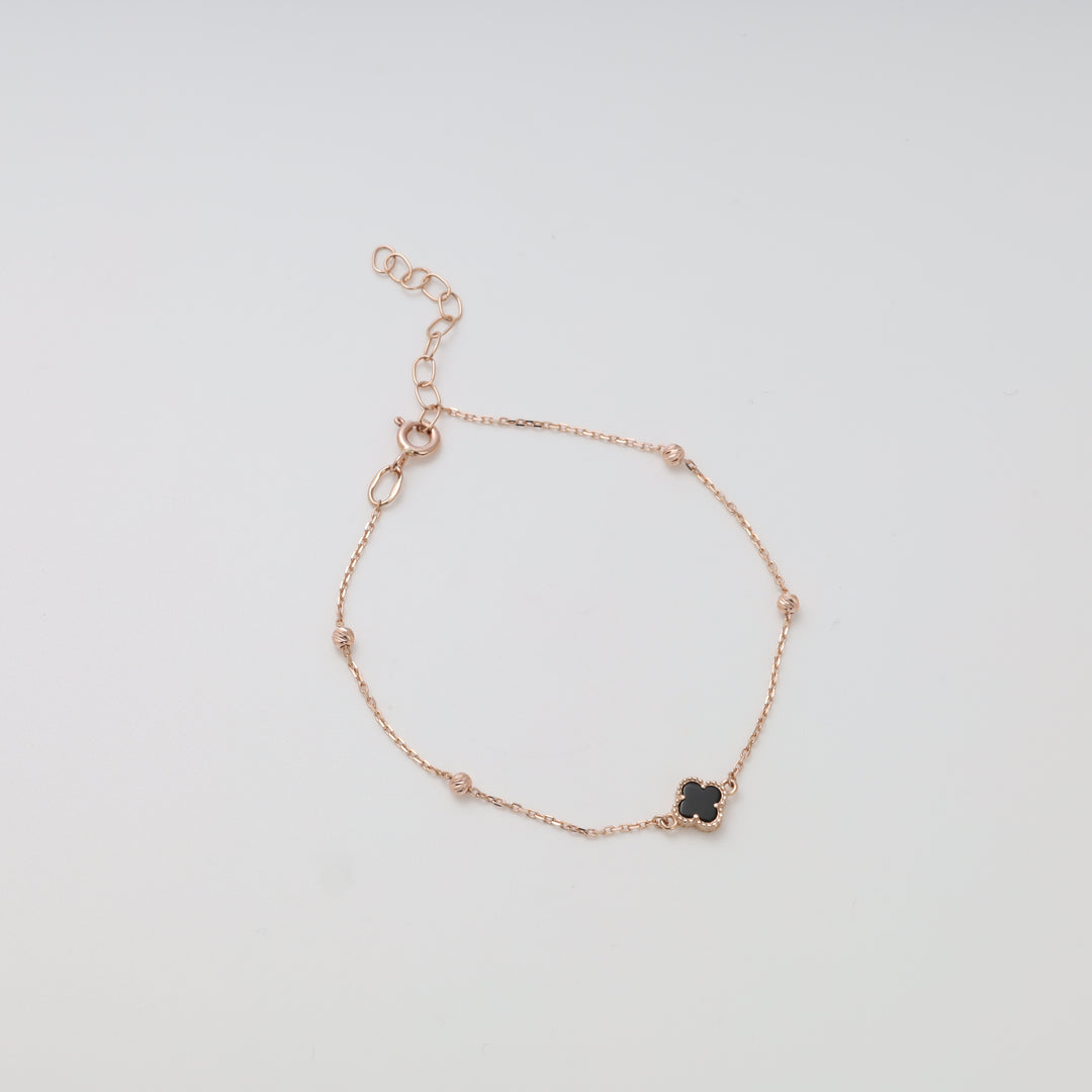 14k gold chain bracelet with black clover charm on white background, delicate gold jewelry, Ukrainian Jewelry, dainty bracelet gift.