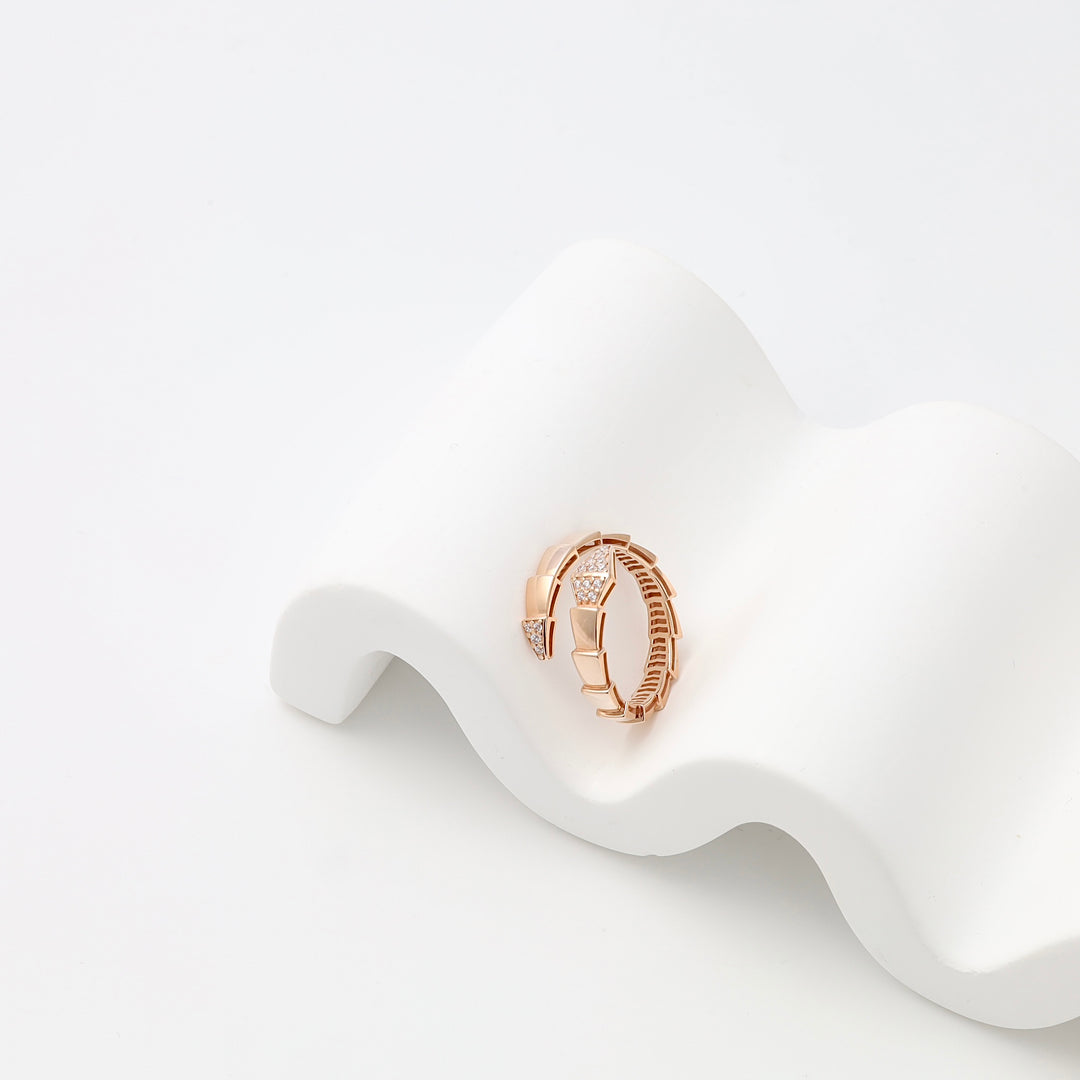Rose gold ring with geometric band and small crystal accents on white display, 14k gold Ukrainian Jewelry, stackable fashion ring.