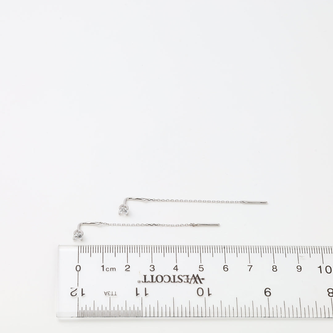 Sterling silver threader chain earrings with small clear stone studs beside a ruler, minimalist Ukrainian Jewelry for women.