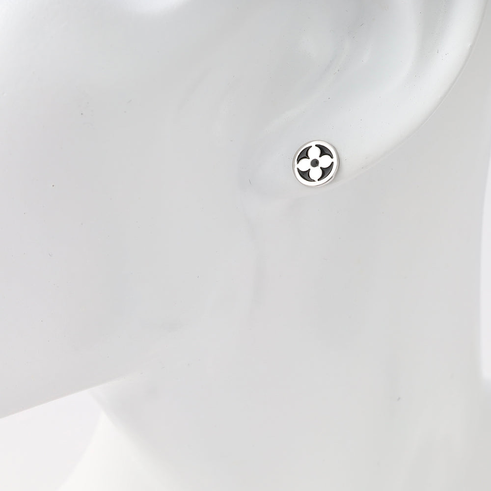 Sterling silver small round stud earring with cutout floral motif on ear, minimalist Ukrainian Jewelry, silver stud earrings for women.