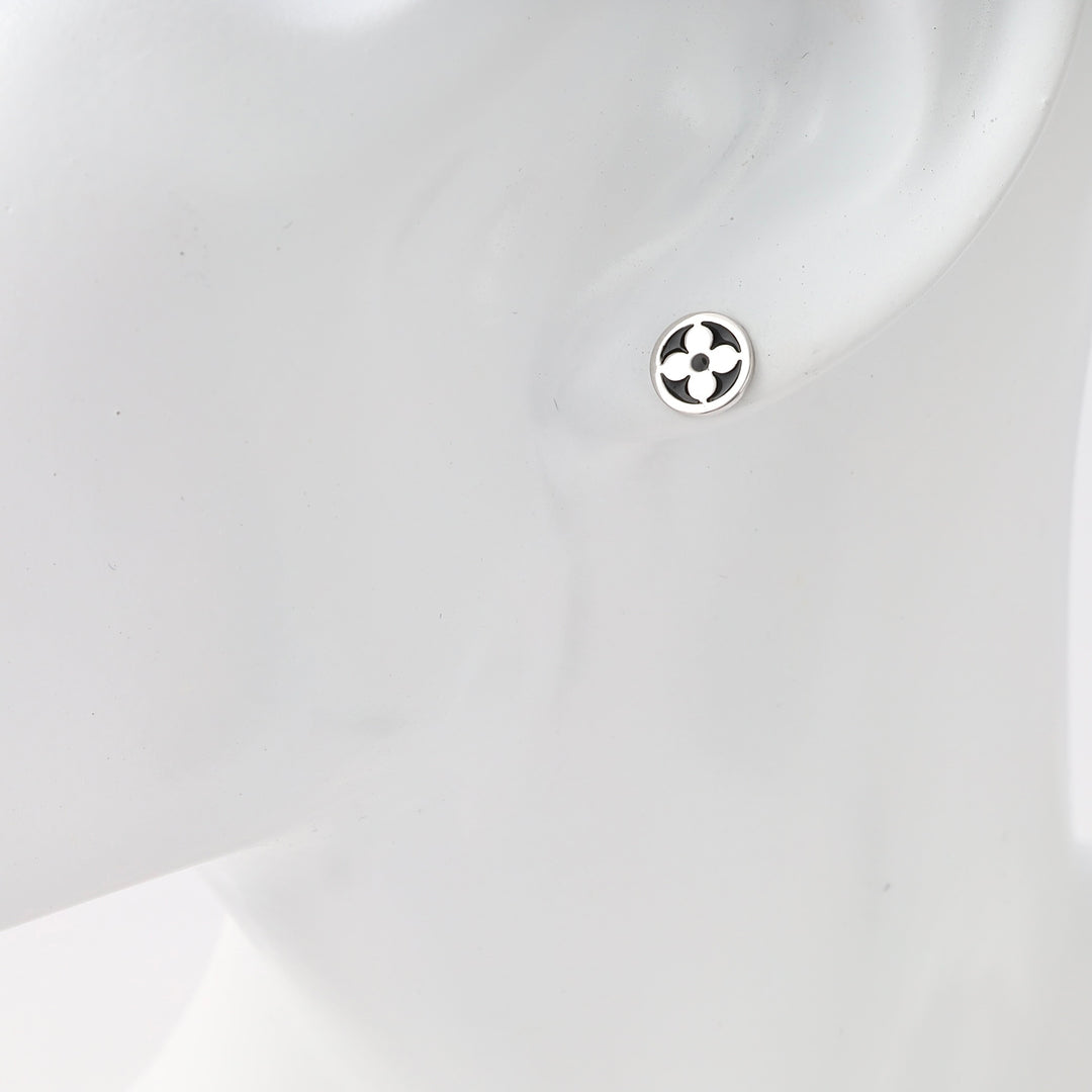 Sterling silver small round stud earring with cutout floral motif on ear, minimalist Ukrainian Jewelry, silver stud earrings for women.