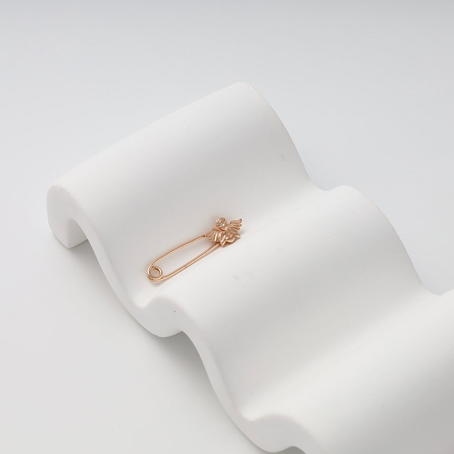 14k gold safety pin brooch with small angel charm on white display, Ukrainian Jewelry, delicate gold pin gift for baby or baptism.