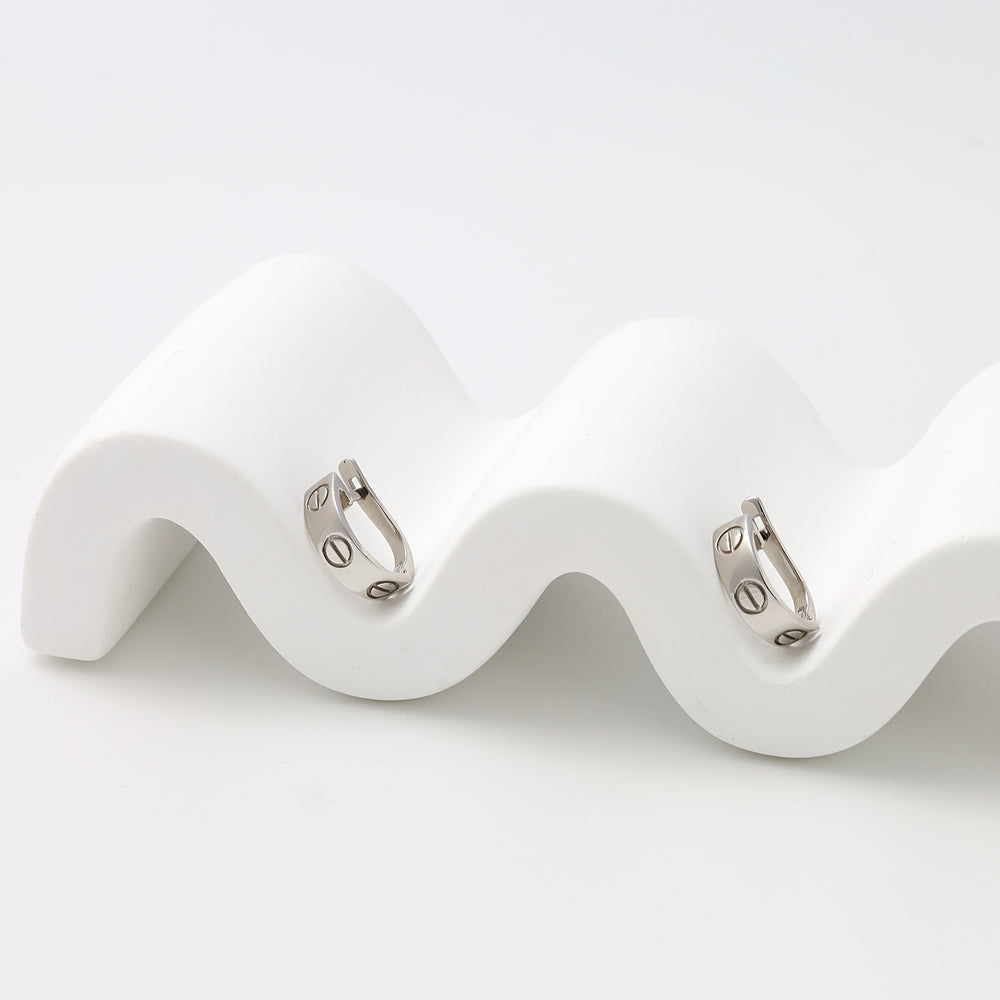 Pair of sterling silver huggie hoop earrings with screw motif on white display, Ukrainian Jewelry, minimalist silver hoop earrings.