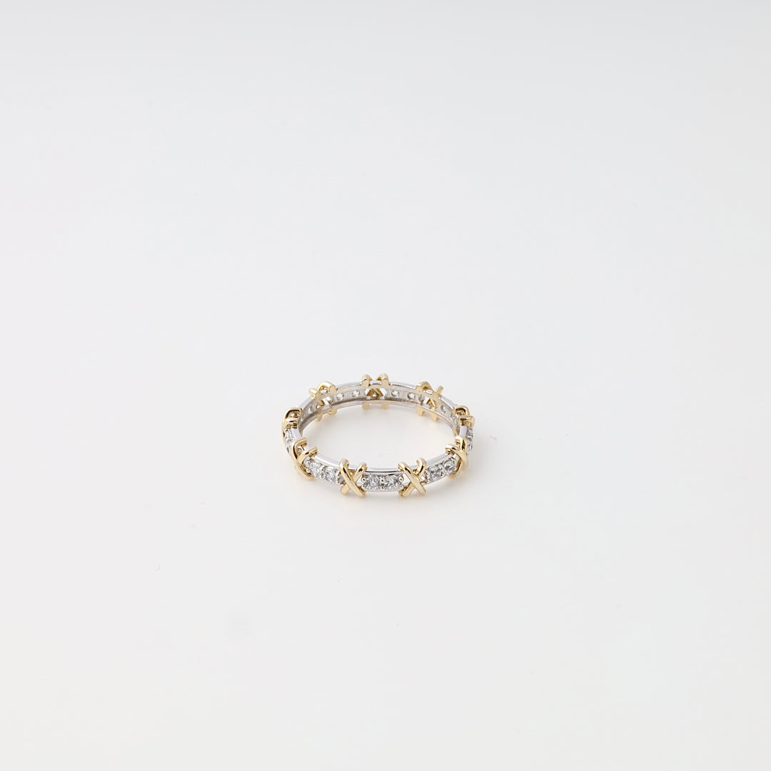 Gold and silver eternity band ring with X motif and small stones on white background, Ukrainian Jewelry, delicate stacking ring.
