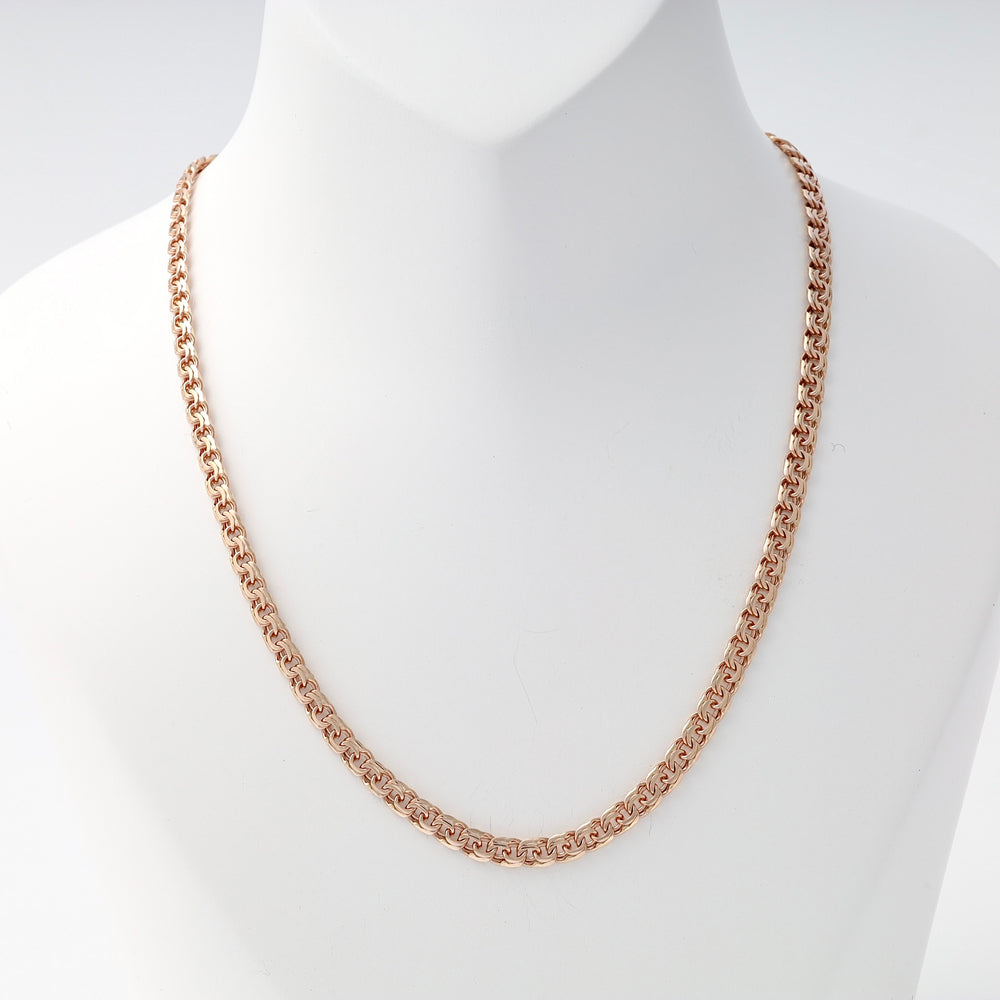 Rose gold chain necklace with intricate Byzantine links displayed on a white bust statue.