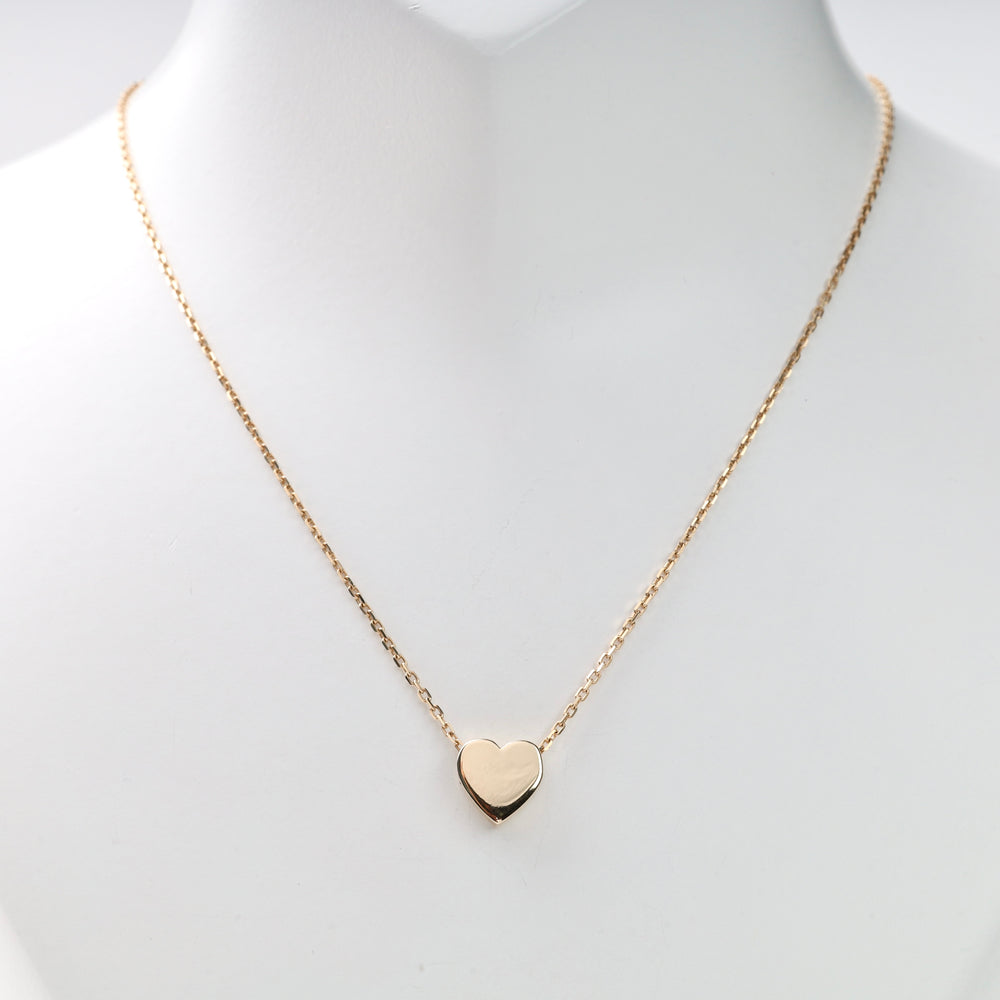 Gold heart pendant on a single gold chain shown on a white display bust, gold heart necklace, heart pendant, gold chain necklace.