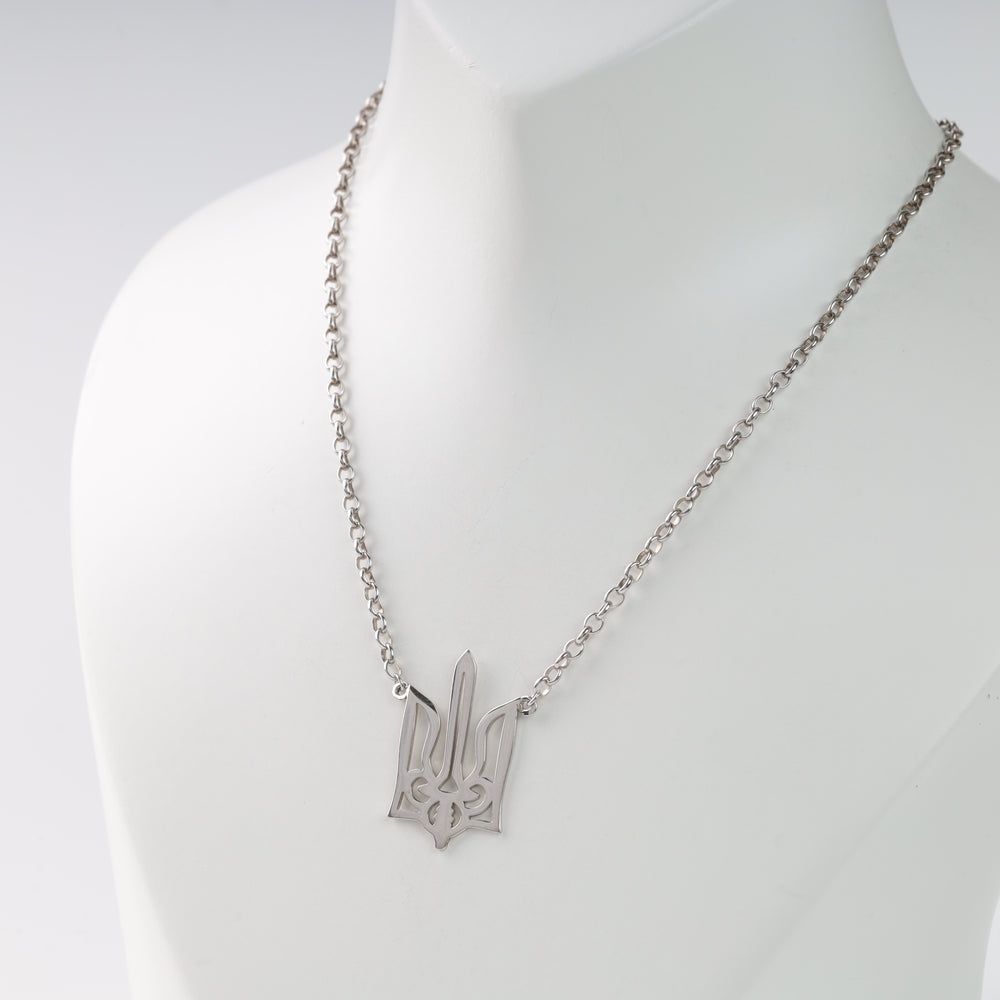 Silver necklace with Ukrainian trident pendant on display bust.