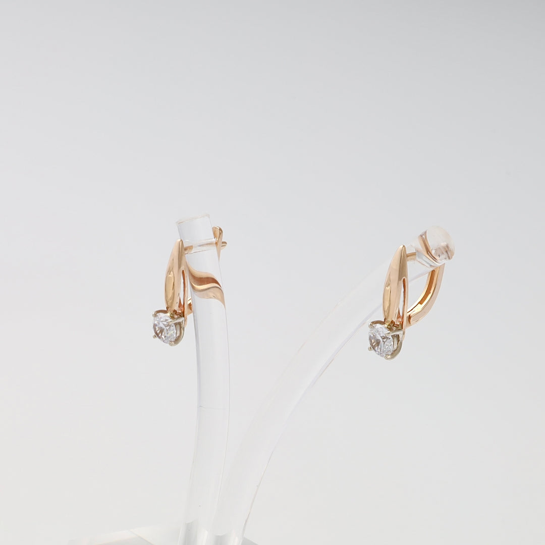 14k gold drop earrings with single clear gemstone studs on display stand, Ukrainian Jewelry, chic gold earrings for women.