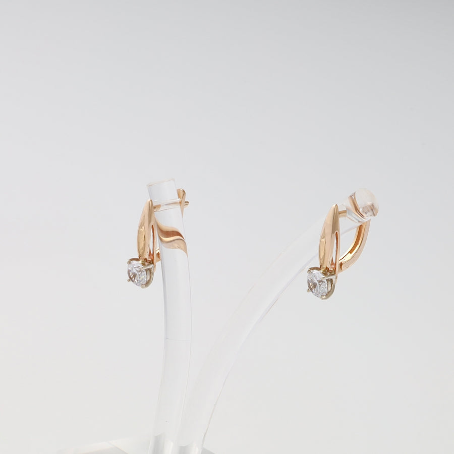 14k gold drop earrings with single clear gemstone studs on display stand, Ukrainian Jewelry, chic gold earrings for women.