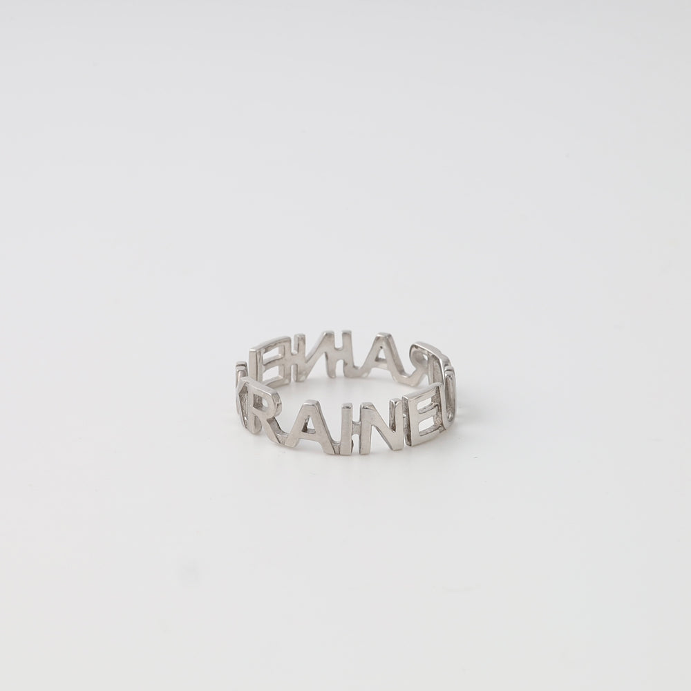Sterling silver word ring with cutout letters on white background, Ukrainian Jewelry, minimalist silver band, custom name ring.