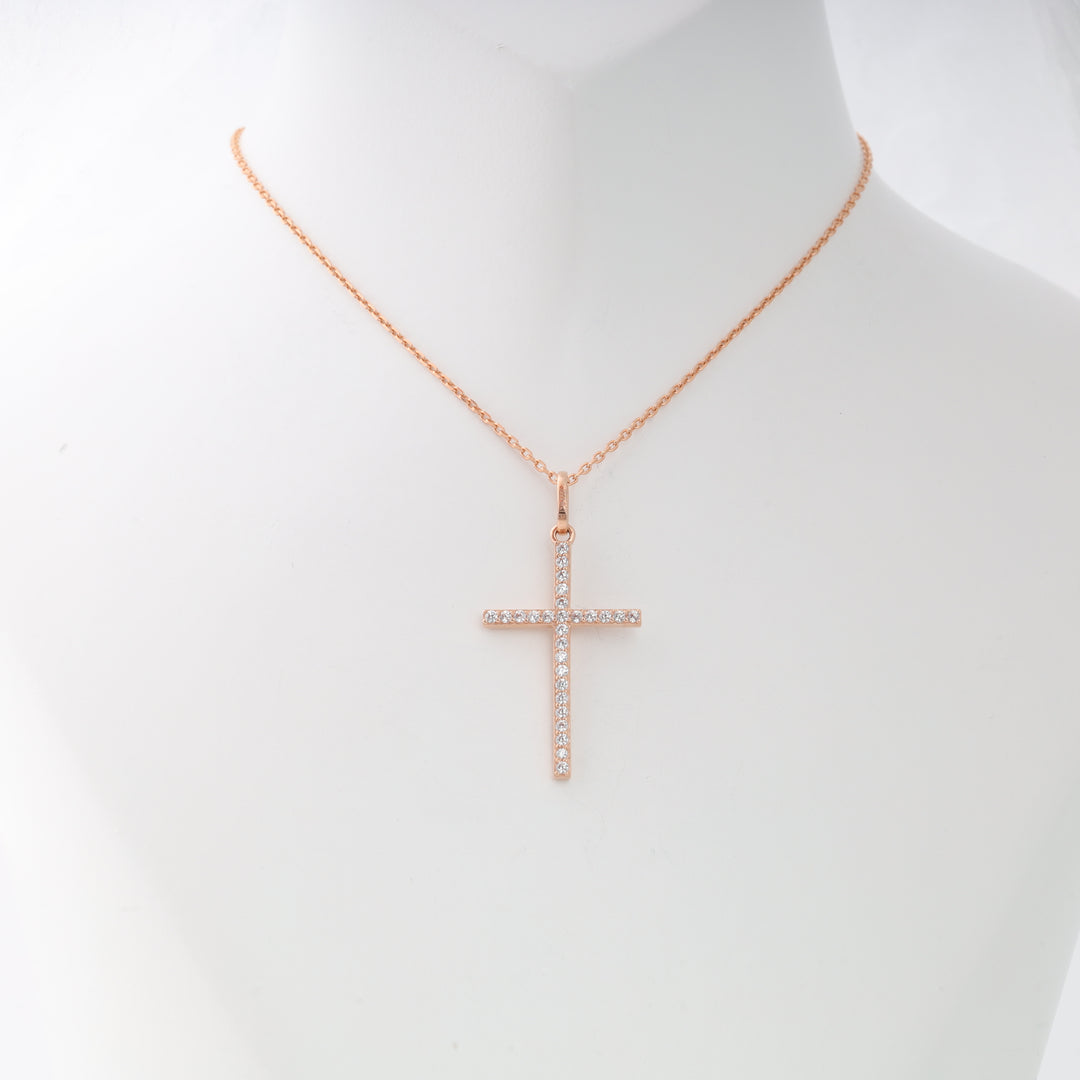 Rose gold necklace with a crystal-studded cross pendant displayed on a white mannequin.