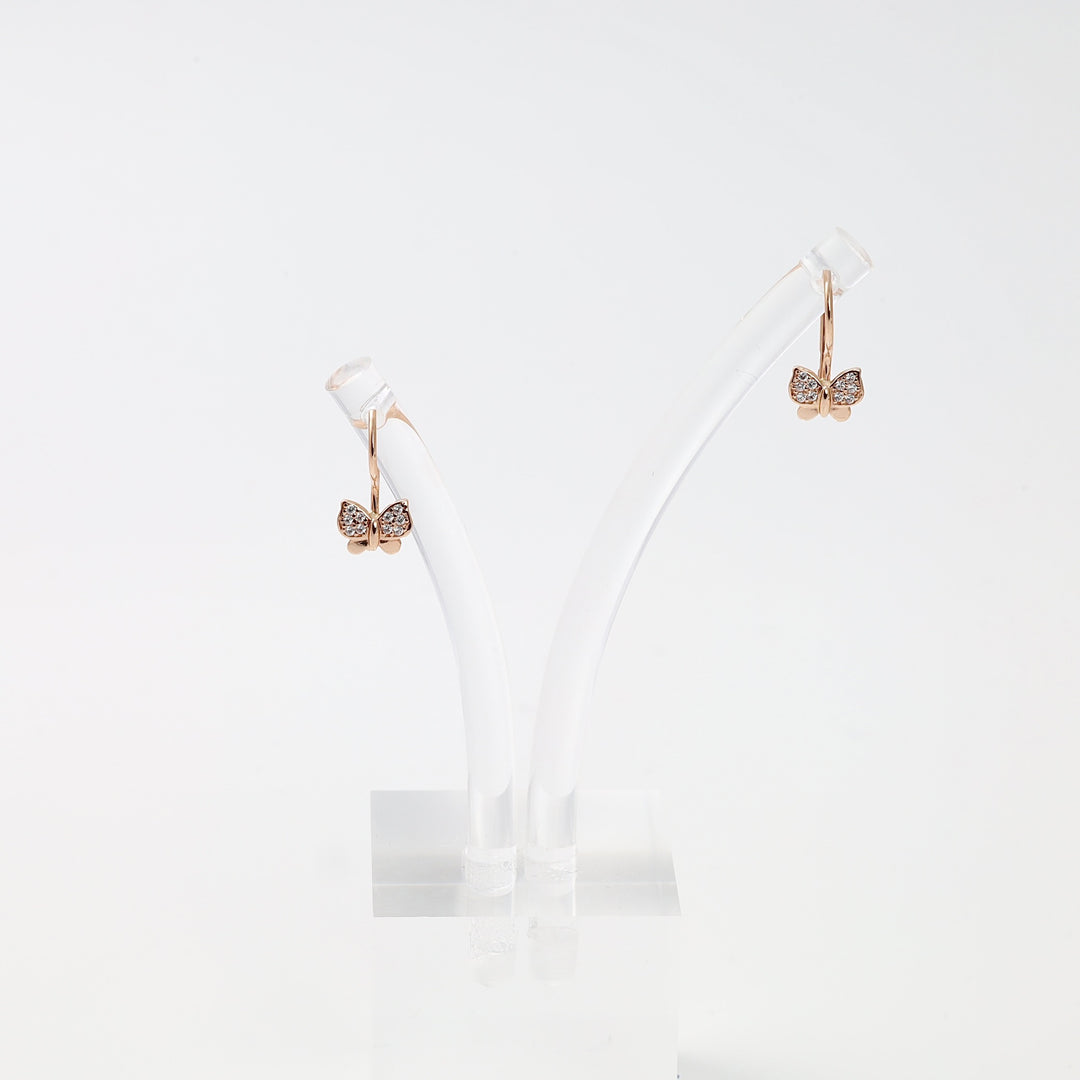 Rose gold butterfly hoop earrings with crystal accents on display stand, 14k gold Ukrainian Jewelry, dainty gold earrings for women.
